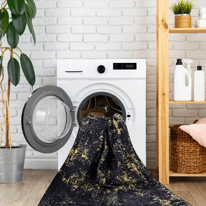 Maval - 6' X 9' Washable Area Rug - Black / Gold