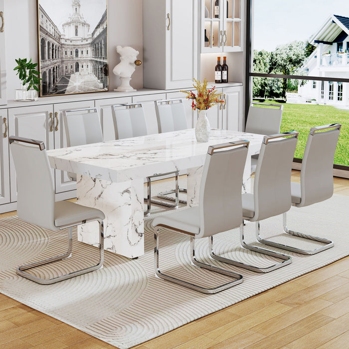 One Piece Of White MDF Material With Patterns On The Dining Table. 8 PU Synthetic Leather High Backrest Cushioned Side Chairs With C-Shaped Silver Metal Legs