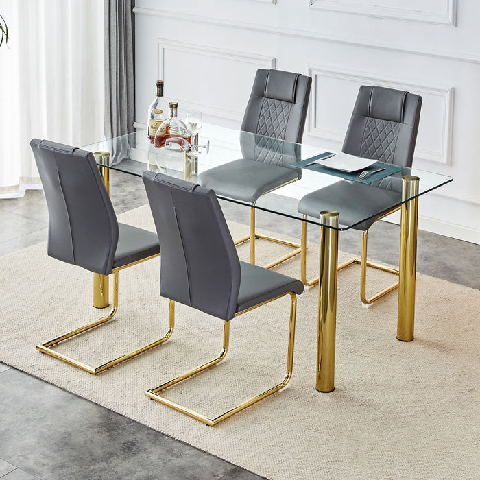 Table And Chair Set, 1 Table With 6 Grey Chairs. Transparent Tempered Glass Tabletop With A Thickness Of 0.3 Feet And Golden Metal Legs. Paired With PU Grey Seat Cushions And Gold Leg Cushioned Seat